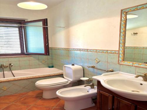 a bathroom with a toilet and a sink and a tub at Holiday Home in Sicily with Private Pool in Francavilla di Sicilia