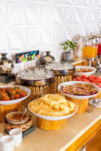 a buffet with many plates of food on a table at Sala Quy Nhon Beach Hotel in Quy Nhon
