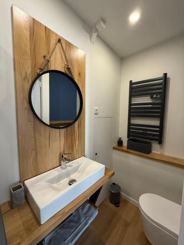 a bathroom with a white sink and a mirror at Au Pont d’Olt in Saint-Côme-dʼOlt