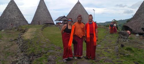 a man and a woman standing in front of somepyramid at FARILA LODGE in Kelimutu