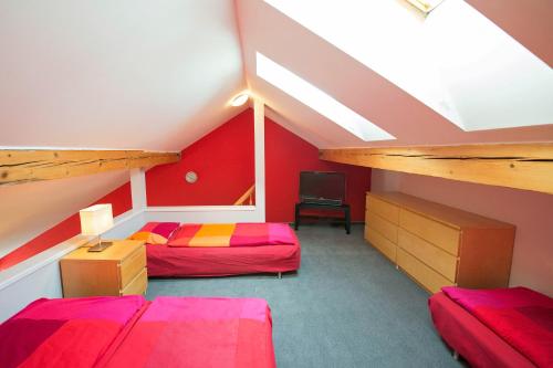 a attic bedroom with two beds and a loft at Apartma Panorama Jeseník in Jeseník