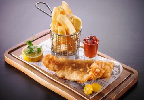 a tray of food with fish and french fries at Temple Bar Hotel Dublin by The Unlimited Collection in Dublin