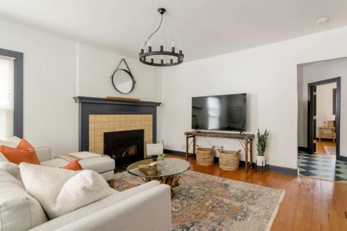 a living room with a white couch and a fireplace at Stay Portland - Spacious Restored Craftsmen - Craft Beer & Coffee in Portland