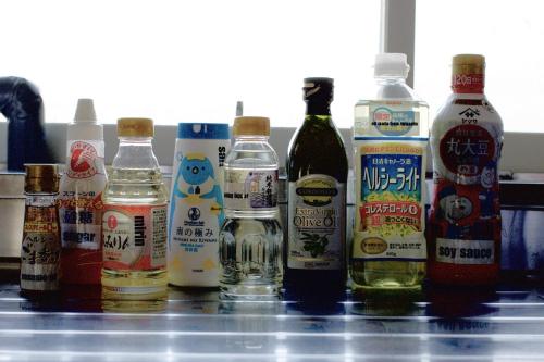 a group of bottles of alcohol sitting on a counter at 期間限定連泊割-新幹線徒歩15分-空港車8分-田んぼに囲まれて暮らす自然に寄り添う静かな一棟貸切宿 in Hanamaki