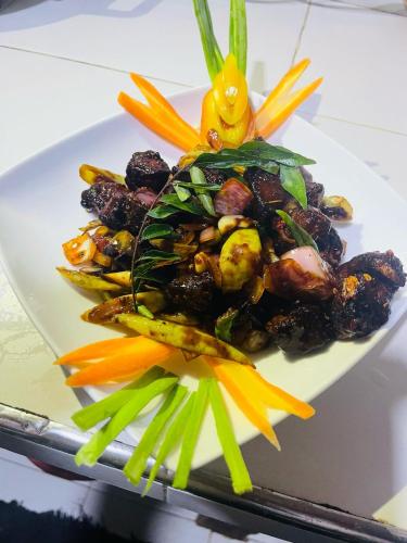 a plate of food with vegetables on a table at The Lake Frost in Nuwara Eliya