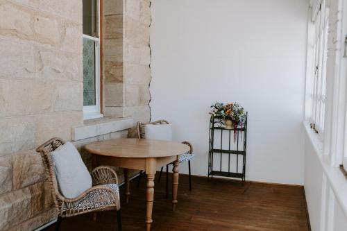 a table and chairs in a room with a window at The Abbey in Warwick