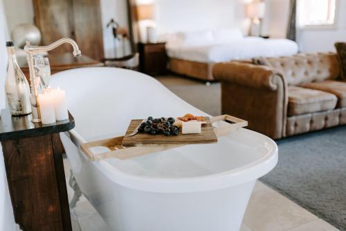 a room with a bed with a tray of food on it at The Abbey in Warwick