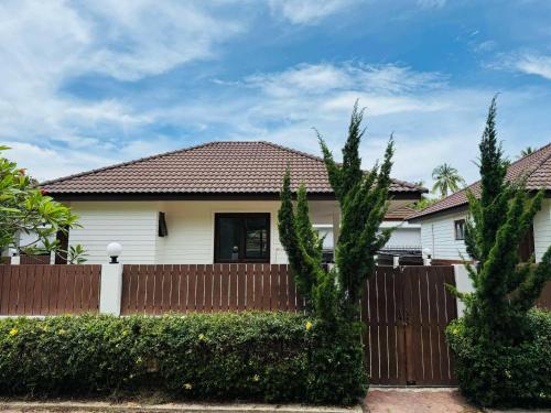 a white house with a wooden fence at Simply Homes in Koh Samui 