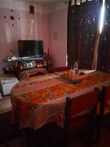 a living room with two tables and a television at Tu Momento de Relax in Quillota