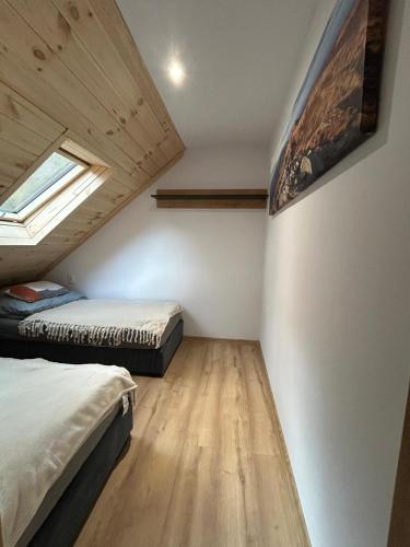 a bedroom with two beds and a window at Połoninka in Ustrzyki Górne