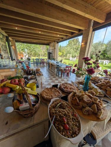 a table with a bunch of food on it at Casale Elisa Country Hotel in Ladispoli