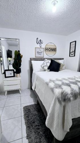 a bedroom with a large bed and a mirror at Haven on the Manor in Kingston