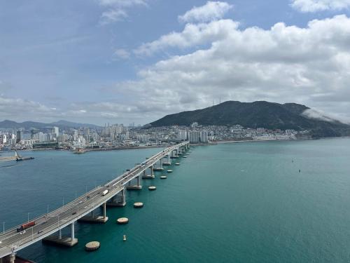 a bridge over the water with a city in the background at THE DECEMBER STAY Busan Songdo Ocean Terrace in Busan