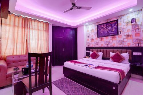 a bedroom with a large bed and a couch at Hotel Royal Sky Luxury Near Delhi Airport in New Delhi