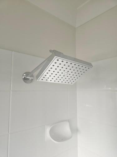 a metal light hanging from the ceiling of a bathroom at Kallangur 3 Bedroom Townhouse in Kallangur