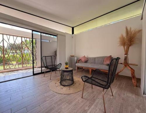 a living room with a couch and chairs at Yopo Resort - Suite Yopal in Yopal