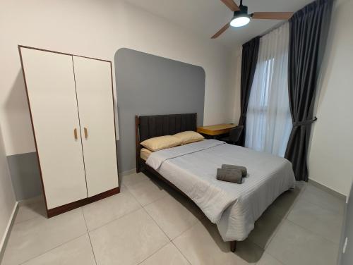 a bedroom with a bed and a dresser and a closet at Cozy 2BR Getaway for 3 YOLO in Petaling Jaya
