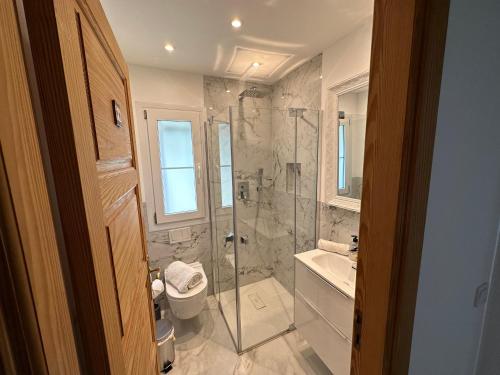 a bathroom with a shower and a toilet and a sink at Poolvilla Patricia - Camp de Mar in Andratx