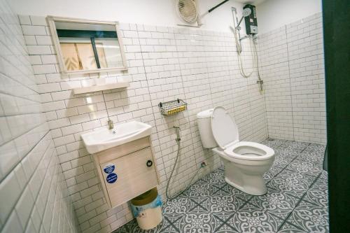 a bathroom with a toilet and a sink at Green Garden House กรีนการ์เด้นเฮ้าส์ นครพนม in Nakhon Phanom