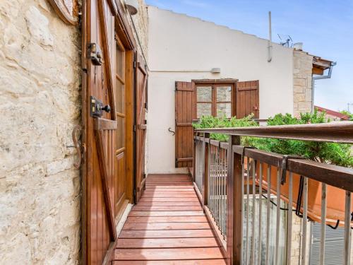a wooden walkway leading to a balcony with a door at Sanders Arsorama Arsos in Arsos