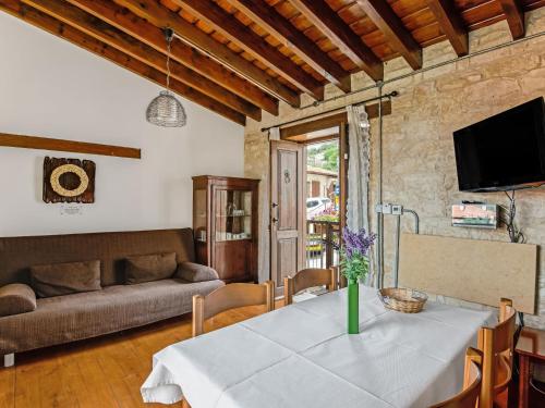 a living room with a table and a couch at Sanders Arsorama Arsos in Arsos