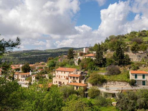 a village on a hill with houses and trees at Sanders Arsorama Arsos in Arsos