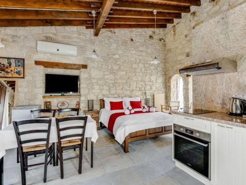 a bedroom with a bed and a table and chairs at Sanders Arsorama Arsos in Arsos