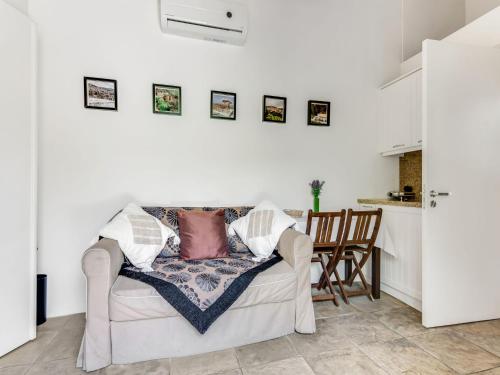 a living room with a couch with pillows on it at Sanders Arsorama Arsos in Arsos