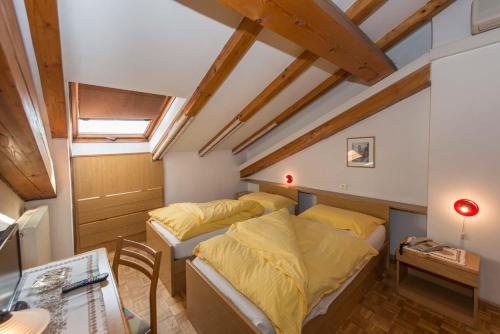 Postel nebo postele na pokoji v ubytování Albergo Antica Rosa