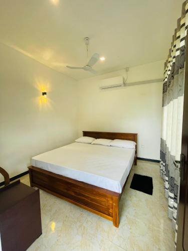 a bedroom with a large bed in a room at Rainforest Mount Villa in Nelluwa