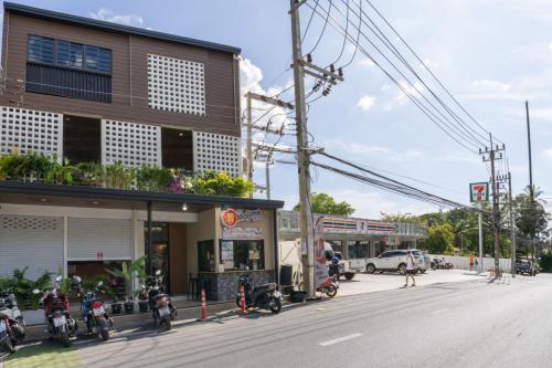 a group of motorcycles parked in front of a building at Mitsu Guesthouse in Karon Beach