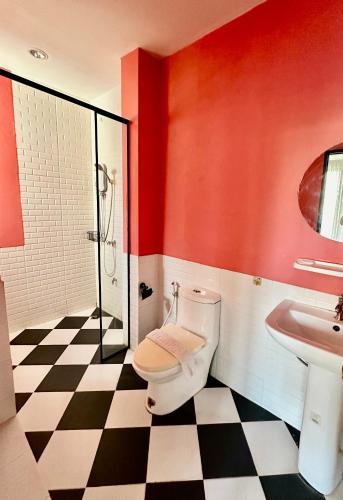 a bathroom with a toilet and a sink at OHDEE Hostel Chiangmai in Chiang Mai