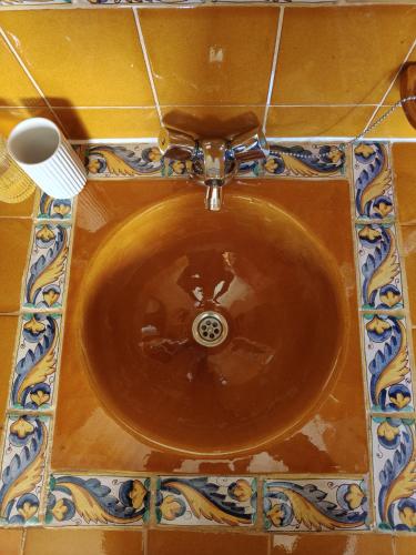 a brown sink in a bathroom with a brush at Casa rural entera en Parque Natural de los Puertos in Alfara de Carles