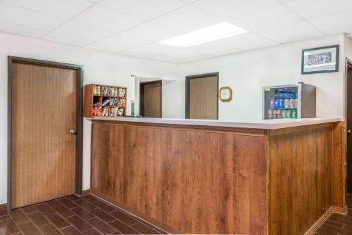 a bar in a waiting room with wood at Super 8 by Wyndham Marshall in Marshall