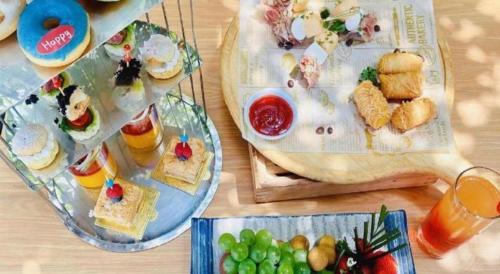 a table with several plates of food on it at Kunming Golden Eagle Summit Hotel in Kunming