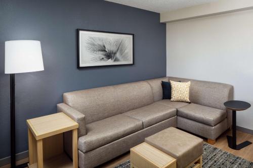 a living room with a couch and a table at Hyatt Place Lake Mary/Orlando North in Lake Mary