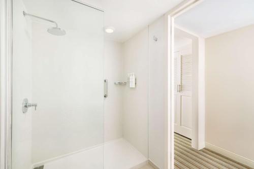 a white bathroom with a glass shower at Embassy Suites by Hilton San Juan - Hotel & Casino in San Juan