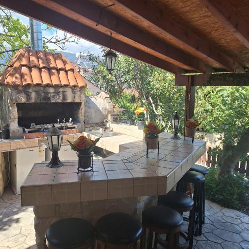 a patio with a table and some chairs and a fireplace at Koukaki in Kouka