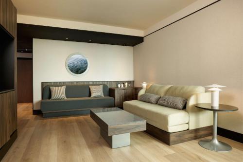 a living room with a couch and a table at Hilton Rome Airport in Fiumicino