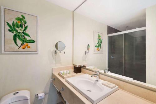 a bathroom with a sink and a toilet at Wyndham Garden Barranquilla in Barranquilla