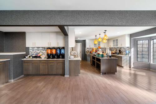 a large kitchen with wooden floors and a counter top at Homewood Suites by Hilton Eatontown in Eatontown