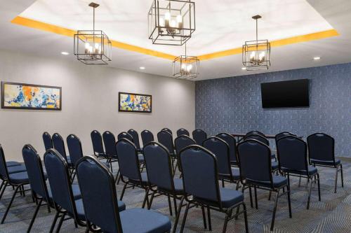 a conference room with chairs and a tv at La Quinta Inn & Suites by Wyndham Austin South in Austin