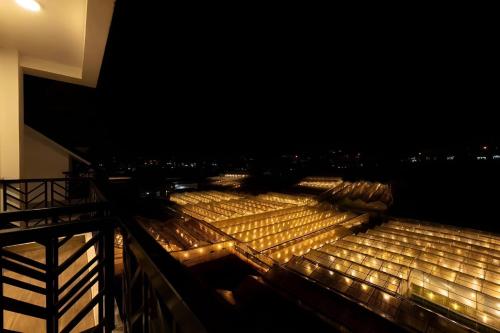 a bunch of lights on a balcony at night at Boho Boutique Da Lat - View nhà lồng lãng mạn in Da Thanh