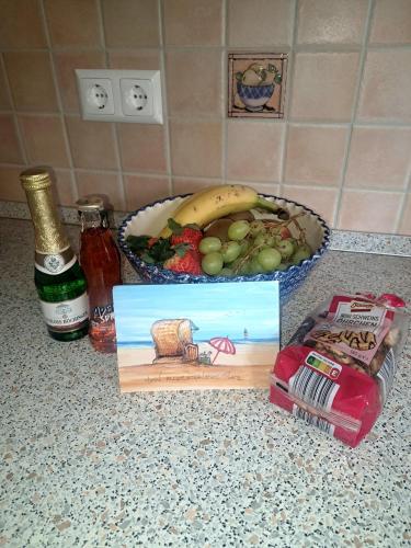 a counter with a bowl of fruit and a plate of food at Ferienhaus-Sophie in Diekhusen-Fahrstedt