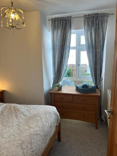 a bedroom with a bed and a window at Westerleigh Annexe - Self-contained accommodation in Langport