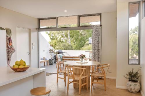 a kitchen and dining room with a table and chairs at Salty Solstice-Beachside Dunsborough Town in Dunsborough