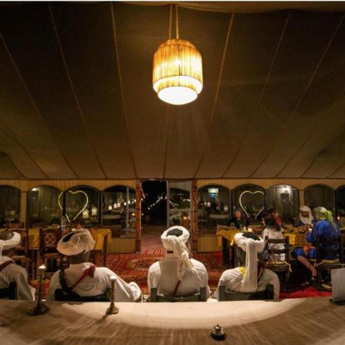 a group of mannequins sitting on a table in a room at Merzouga Horizon Luxury Camp in Merzouga