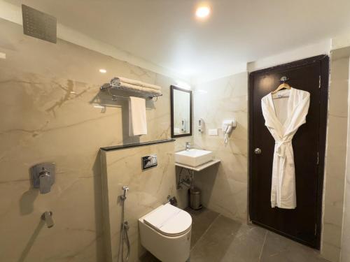 a bathroom with a toilet and a sink at Hotel Landridge - HITECH City Hyderabad in Hyderabad
