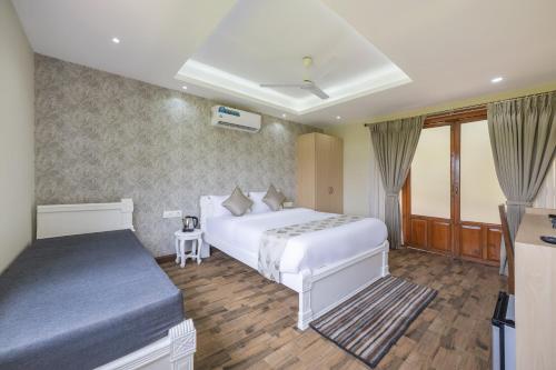 a bedroom with a white bed and a window at Echor La Blanca Resort Mandrem Goa in Mandrem