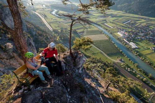 two people riding a zipline up a mountain at Chalet Pirchhof inklusive Summercard by MYALPS in Sautens